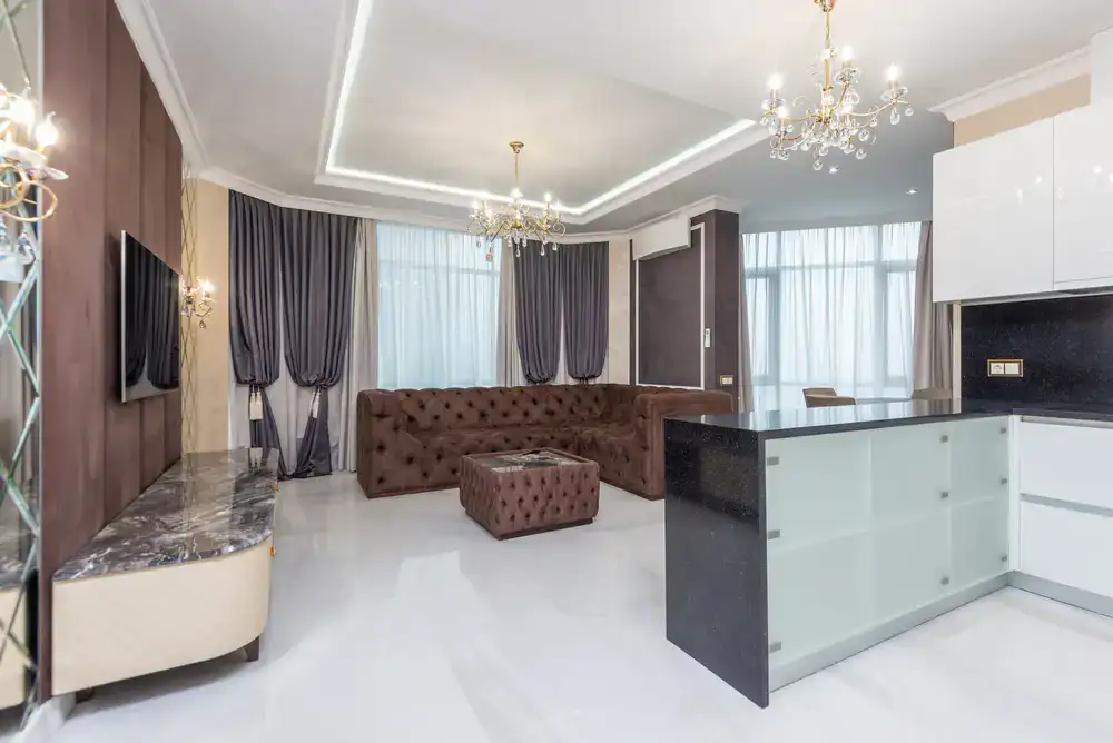Elegant modern living room furnished by Veda Furniture with rich wooden textures